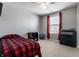 Bedroom with a plaid bedspread, a ceiling fan, and a window with red curtains at 12729 Brandenburg Dr, Carmel, IN 46032