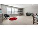 Spacious bonus room with a telescope, a chair, and a red rug at 12729 Brandenburg Dr, Carmel, IN 46032