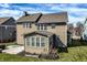 Back of home with large windows, a covered patio, and a well-maintained lawn on a sunny day at 12729 Brandenburg Dr, Carmel, IN 46032