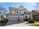 Traditional two-story home featuring a 3-car garage, well-kept lawn, and classic architectural details at 12729 Brandenburg Dr, Carmel, IN 46032