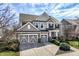 Charming two-story home with attached two-car garage and beautifully manicured landscaping at 12729 Brandenburg Dr, Carmel, IN 46032