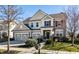 Inviting two-story home with a neatly manicured lawn, a mailbox, and a welcoming front entrance at 12729 Brandenburg Dr, Carmel, IN 46032