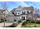 Charming two-story home with a well-manicured lawn, three-car garage, and inviting front entrance exudes curb appeal at 12729 Brandenburg Dr, Carmel, IN 46032