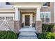 Covered front porch with brick accents, offering a cozy entrance to this beautiful home at 12729 Brandenburg Dr, Carmel, IN 46032