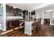 Modern kitchen boasts dark cabinets, granite countertops, stainless appliances and breakfast bar at 12729 Brandenburg Dr, Carmel, IN 46032