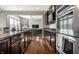 Open kitchen with stainless appliances, granite counters, wood floors that looks into the living room at 12729 Brandenburg Dr, Carmel, IN 46032