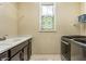 Laundry room features modern appliances, plenty of counter space, and natural light at 12729 Brandenburg Dr, Carmel, IN 46032