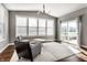 Bright living room featuring large windows, hardwood floors, and neutral decor at 12729 Brandenburg Dr, Carmel, IN 46032