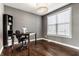 Well-lit home office with hardwood floors, a large window, and a functional workspace at 12729 Brandenburg Dr, Carmel, IN 46032