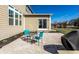 Charming outdoor patio area, perfect for entertaining, featuring a stone paved surface and cozy seating under a clear blue sky at 12729 Brandenburg Dr, Carmel, IN 46032