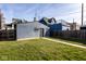 This backyard features green grass, partial view of neighboring buildings and a fence at 1334 E Market St, Indianapolis, IN 46202