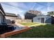 Backyard featuring a wood deck, green grass, partial view of neighboring buildings, and a fence at 1334 E Market St, Indianapolis, IN 46202