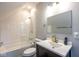 Bathroom features a white vanity and shower-tub combo with a white subway tile surround at 1334 E Market St, Indianapolis, IN 46202