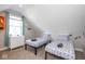 Bedroom with two twin beds features a slanted ceiling and geometric-patterned bedding at 1334 E Market St, Indianapolis, IN 46202