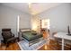 Comfortable bedroom featuring a convenient Murphy bed, a cozy chair, and a well-lit workstation at 1334 E Market St, Indianapolis, IN 46202