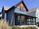 Charming two-story home with blue siding, an orange gable, black trim, and a covered front porch with modern railing at 1334 E Market St, Indianapolis, IN 46202