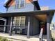 Welcoming front porch with seating, a stylish wood ceiling, dark trim, and contemporary railings at 1334 E Market St, Indianapolis, IN 46202