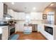 Charming kitchen with stainless steel appliances, white cabinets, and hardwood floors at 1334 E Market St, Indianapolis, IN 46202