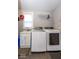 Well-lit laundry room with modern washer and dryer, sink, and storage space at 1334 E Market St, Indianapolis, IN 46202