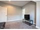 Neutral-toned room featuring gray carpet, a television, and plenty of natural light at 1334 E Market St, Indianapolis, IN 46202