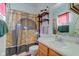 Bathroom featuring a Harry Potter themed shower curtain, sink, and shelving at 1360 Evergreen Dr, Greenfield, IN 46140