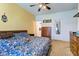 Bedroom with ceiling fan, bright wall colors, and wood furnishings at 1360 Evergreen Dr, Greenfield, IN 46140