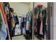 Walk-in closet with mirror, wire racks, and lots of hanging clothing at 1360 Evergreen Dr, Greenfield, IN 46140