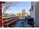 Charming outdoor deck with seating, grill, and a view of the green backyard and neighborhood at 1360 Evergreen Dr, Greenfield, IN 46140