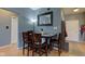 Cozy dining area with wood table and seating under a decorative mirror, adjacent to the entry at 1360 Evergreen Dr, Greenfield, IN 46140