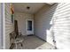A cozy front porch featuring a charming bench, a decorative table, and a welcoming entrance with a screen door at 1360 Evergreen Dr, Greenfield, IN 46140
