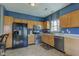 Kitchen area featuring wooden cabinets, stainless steel appliances, and ample counter space at 1360 Evergreen Dr, Greenfield, IN 46140