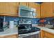 Close-up of the kitchen with stainless steel oven and microwave, with white countertops at 1360 Evergreen Dr, Greenfield, IN 46140