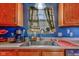 Well-lit kitchen sink with stainless steel faucet, ample counter space and storage above at 1360 Evergreen Dr, Greenfield, IN 46140