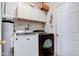 Functional laundry room with modern washer and dryer, white cabinets, and water heater at 1360 Evergreen Dr, Greenfield, IN 46140