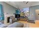 A stylish living room featuring a projector screen, fireplace, comfortable seating, and a ceiling fan for added comfort at 1360 Evergreen Dr, Greenfield, IN 46140