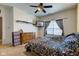 Bright bedroom with ceiling fan, and two dressers, next to a large window at 1360 Evergreen Dr, Greenfield, IN 46140