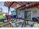 Covered patio with a swing, grill, and seating area, great for outdoor entertaining at 1360 Evergreen Dr, Greenfield, IN 46140