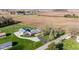 An aerial shot of a home showcasing a pool, long driveway, outbuildings, and expansive farmland at 139 W Jefferson St, Jamestown, IN 46147