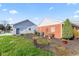 Well-maintained backyard includes a charming mix of lush green grass, mulched garden beds, and manicured landscaping at 139 W Jefferson St, Jamestown, IN 46147