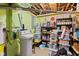 Unfinished basement with exposed ceiling pipes, water filtration system, storage shelves, offering potential for customization at 139 W Jefferson St, Jamestown, IN 46147
