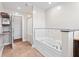 A luxurious bathroom features a modern bathtub, tiled wall, and convenient shelf, offering style and functionality at 139 W Jefferson St, Jamestown, IN 46147