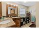 Bathroom with double sink vanity, neutral countertops and backsplash, a modern mirror and plenty of storage at 139 W Jefferson St, Jamestown, IN 46147