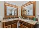 Charming bathroom showcasing dual sinks with elegant mirrors, granite countertops and plenty of under sink cabinetry at 139 W Jefferson St, Jamestown, IN 46147