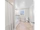 Bright bathroom featuring a tub with shower, a toilet, and tiled floor and a window at 139 W Jefferson St, Jamestown, IN 46147