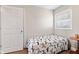 Cozy bedroom features a window for natural light and a comfortable bed with patterned bedding at 139 W Jefferson St, Jamestown, IN 46147