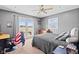 Well-lit bedroom featuring a ceiling fan, a balcony entrance, and neutral wall color at 139 W Jefferson St, Jamestown, IN 46147