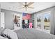 Comfortable bedroom with ceiling fan, balcony access, TV, and American flag decor at 139 W Jefferson St, Jamestown, IN 46147