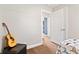 Bedroom with a guitar on a leather ottoman and an open doorway to another bedroom at 139 W Jefferson St, Jamestown, IN 46147