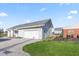 An oversized garage with plenty of space for parking and storage, as well as a manicured lawn at 139 W Jefferson St, Jamestown, IN 46147