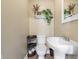 Cozy half-bathroom with decorative accents including a pedestal sink and shelf decorations at 139 W Jefferson St, Jamestown, IN 46147